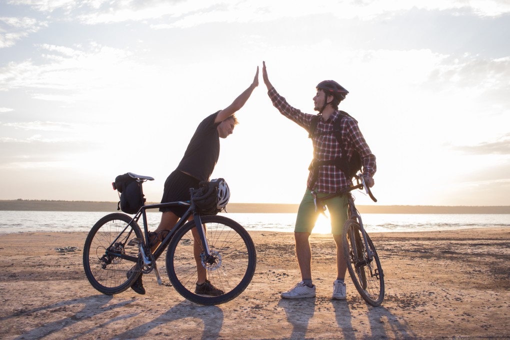 Physical contact, including hugs and the high five (above), is being avoided during the pandemic. Photo: Shutterstock