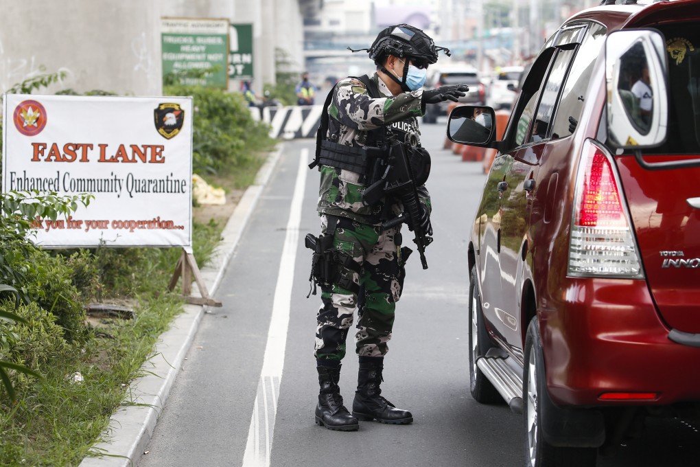 A Philippine police officer at a quarantine checkpoint in Metro Manila. Photo: EPA