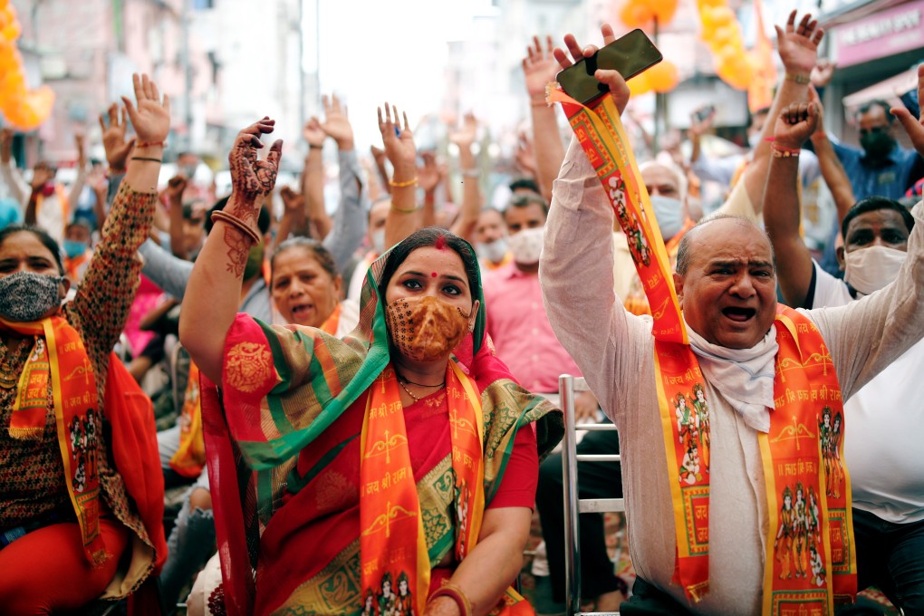 Indians watch a live screening of Prime Minister Narendra Modi taking part in the stone-laying ceremony for the Ram temple in Ayodhya. Photo: Reuters