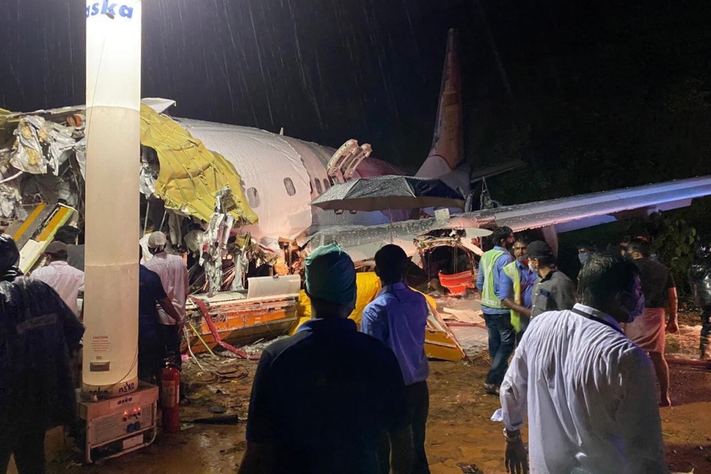 Officials inspect the site of a plane crash at Calicut airport in Kozhikode, India on Friday. Photo: Indian Civil Defence handout via EPA-EFE