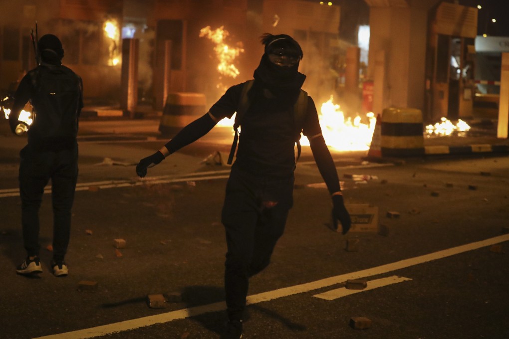 Pro-democracy protesters firebomb the toll gates to the Cross-Harbour Tunnel on November 14, 2019. Photo: AP