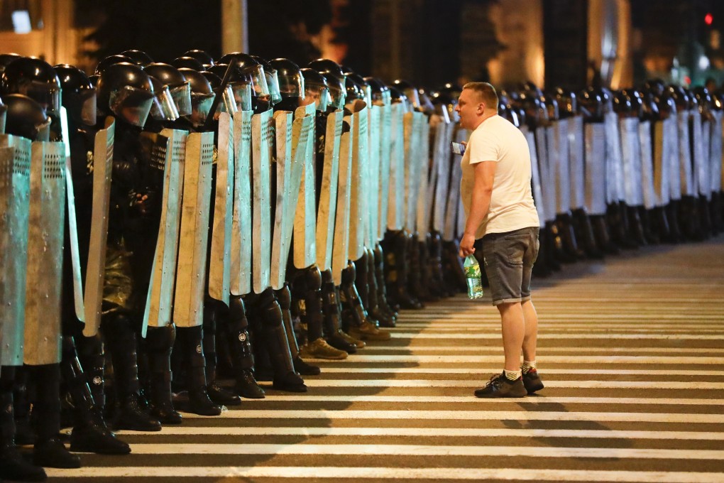 A protester speaks to police as they block the road during a rally after the Belarusian presidential election in Minsk, Belarus. Photo: AP