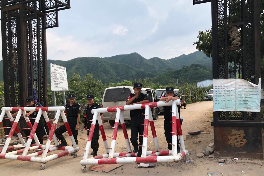 Security guards block one of the entrances to Xitai village in northern Beijing. Photo: Handout