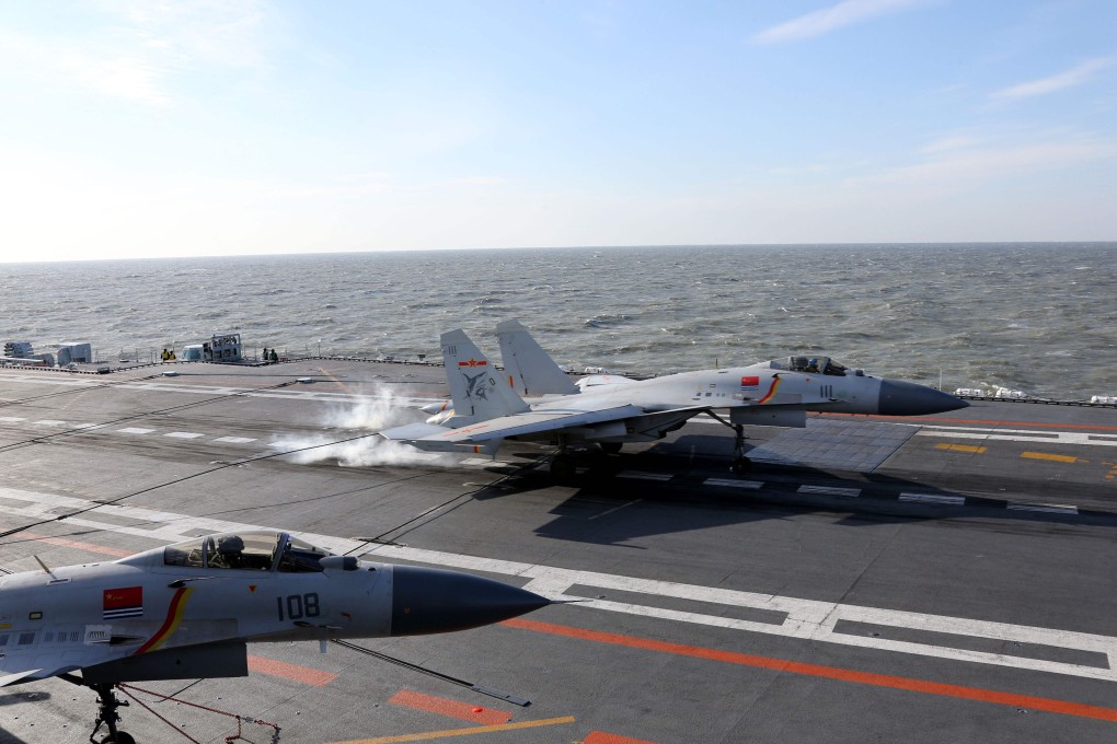 A J-15 fighter jet lands on China’s first aircraft carrier, the Liaoning – but it is adding to its fleet, requiring more pilots. Photo: AFP
