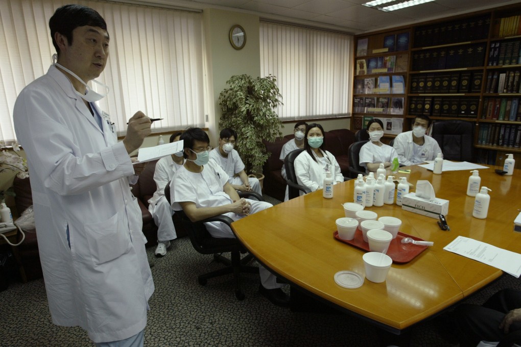 Dr Joseph Sung, then chairman of the Prince of Wales Hospital’s department of medicine and therapeutic, conducts a daily meeting with medical staff during the height of 2003’s Sars epidemic. Photo: SCMP
