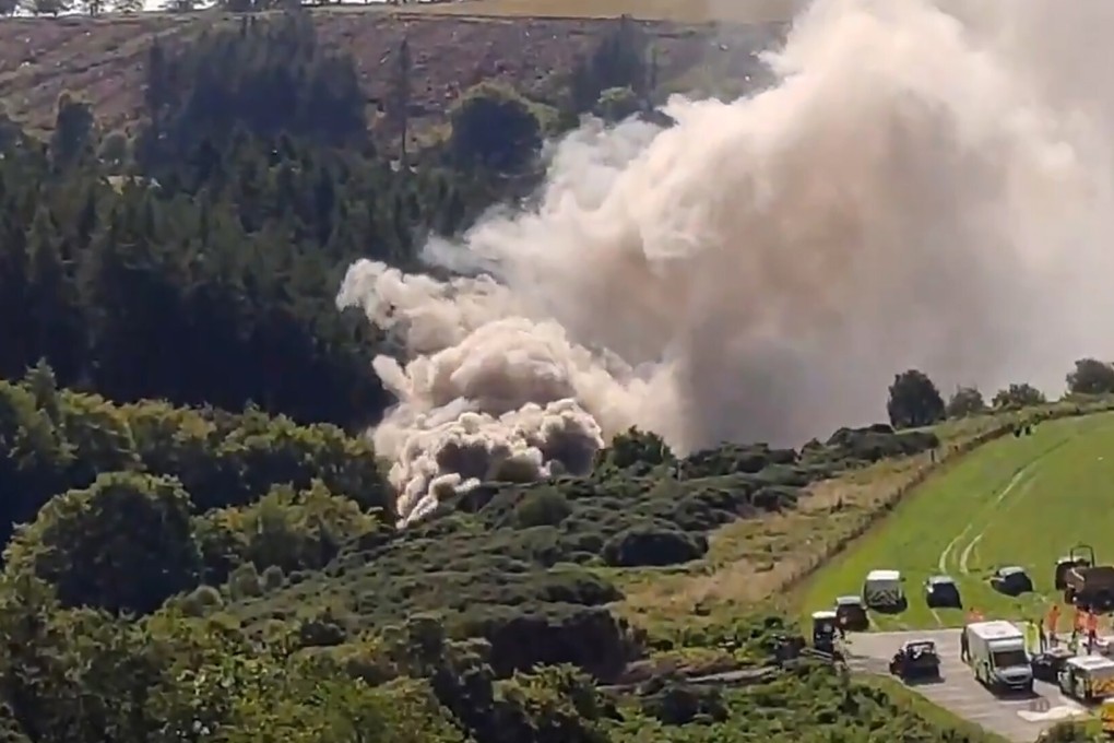Smoke billows from a derailed train in the countryside near Stonehaven, Scotland. Photo: Chris Harvey, STV News via AFP