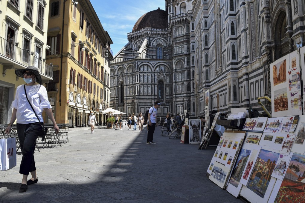 Picture sellers on another quiet day outside the Duomo di Firenze, in Florence, Italy. Photo: Red Door News