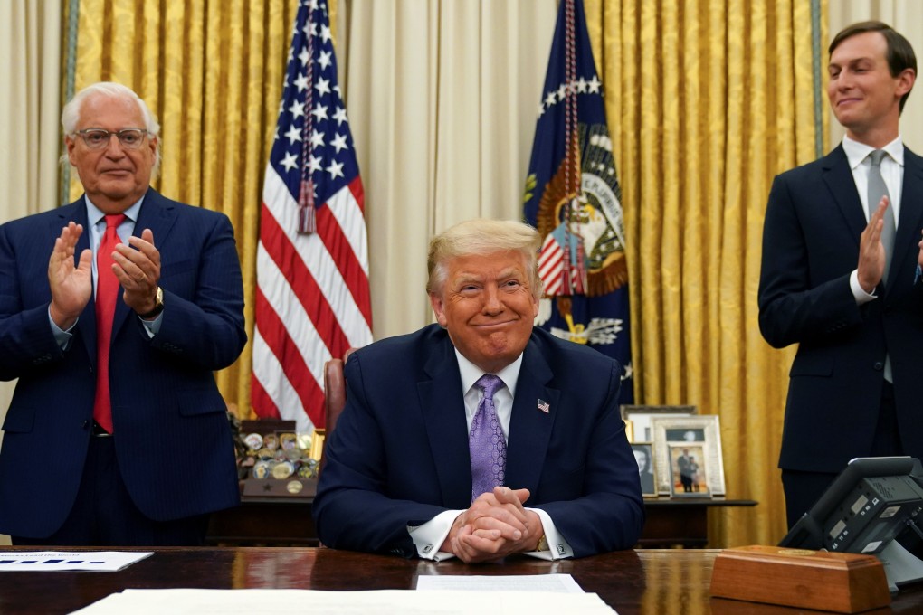 U.S. Ambassador to Israel David Melech Friedman (left) and White House senior adviser Jared Kushner applaud after US President Donald Trump announced a peace deal between Israel and the United Arab Emirates on Thursday. Photo: Reuters