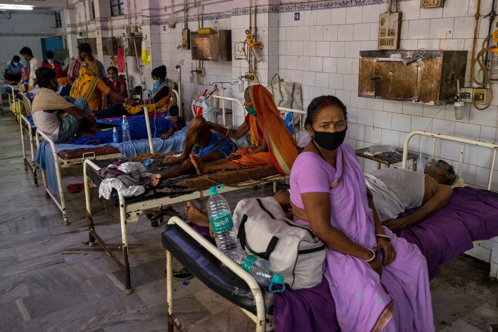 A woman sits on a hospital bed in Bhagalpur while her husband, a Covid-19 patient, waits to be transferred to ICU. Medical experts say India will reach 3 million cases in the next 10 days. Photo: Reuters