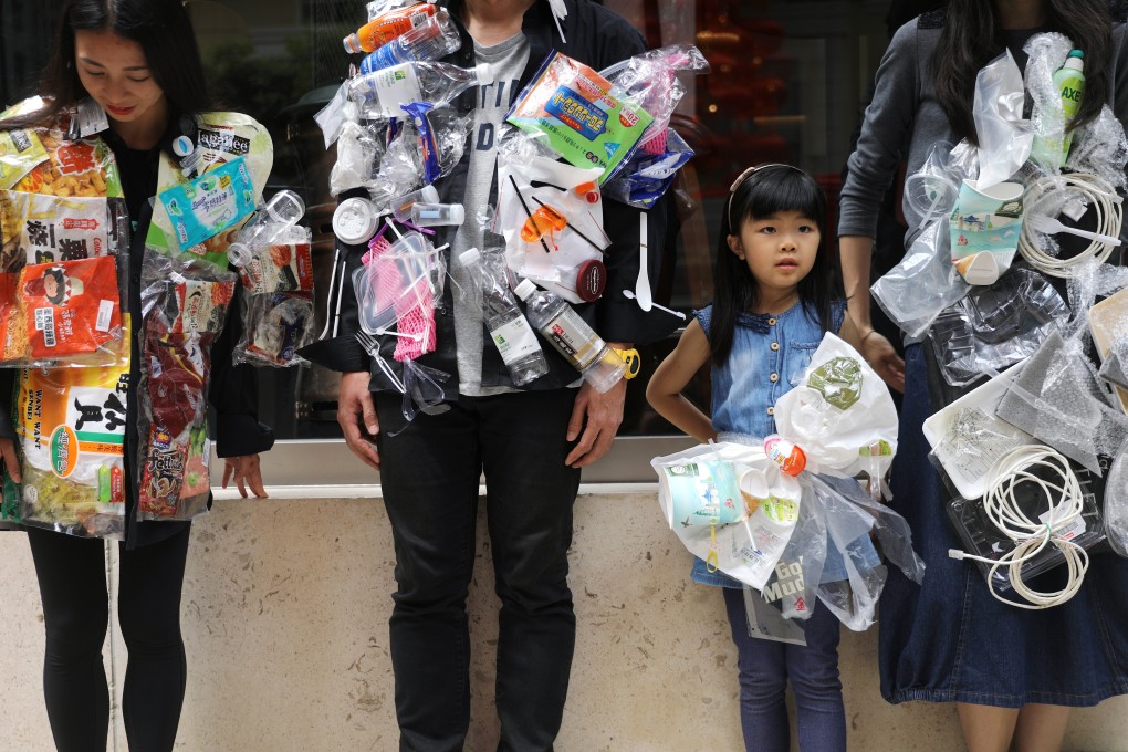 A child joins environmental activists wearing jackets made of plastic waste as they appeal for a plastic-free future to mark International Earth Day, in Wan Chai in April 2018. Photo: Sam Tsang