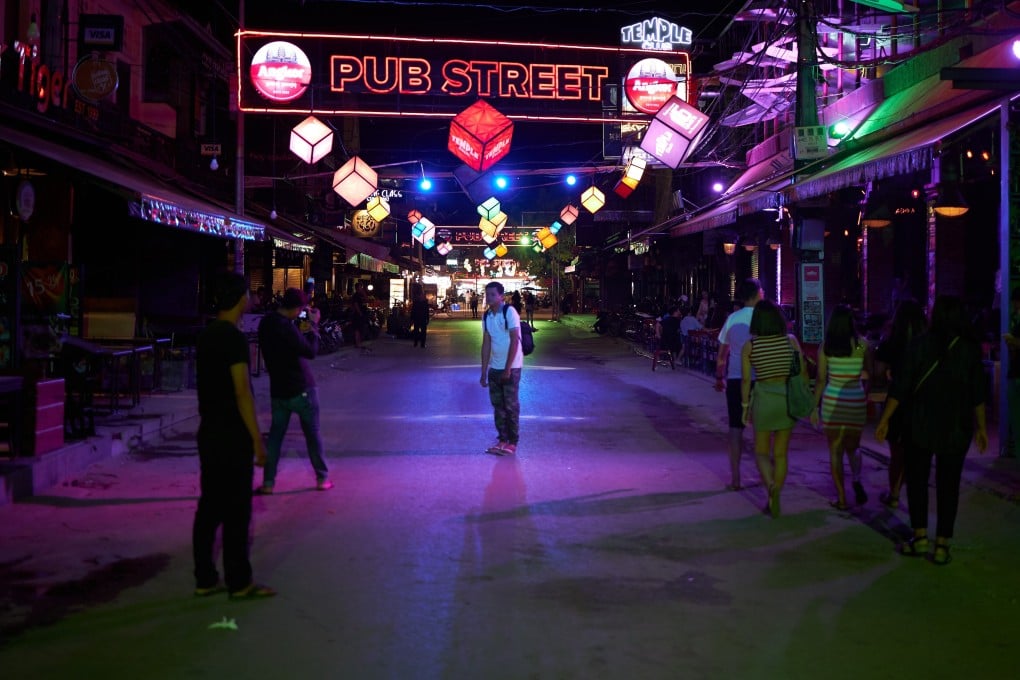 Just a handful of visitors populate Pub Street in Siem Reap, Cambodia, on a recent evening – a far cry from the busy crowds and hedonistic atmosphere of the party strip just eight months ago. Photo: Jorge Rodriguez