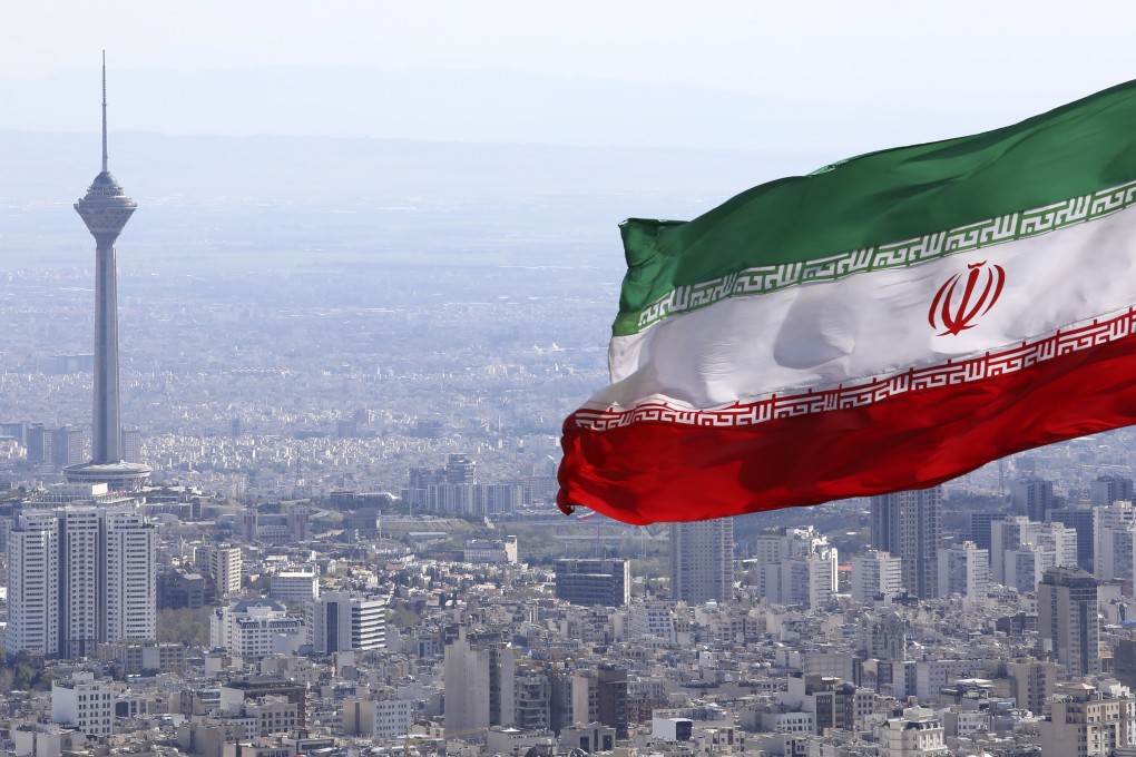 Iran's national flag waves as the Milad telecommunications tower and buildings are seen in Tehran, Iran. Photo: AP