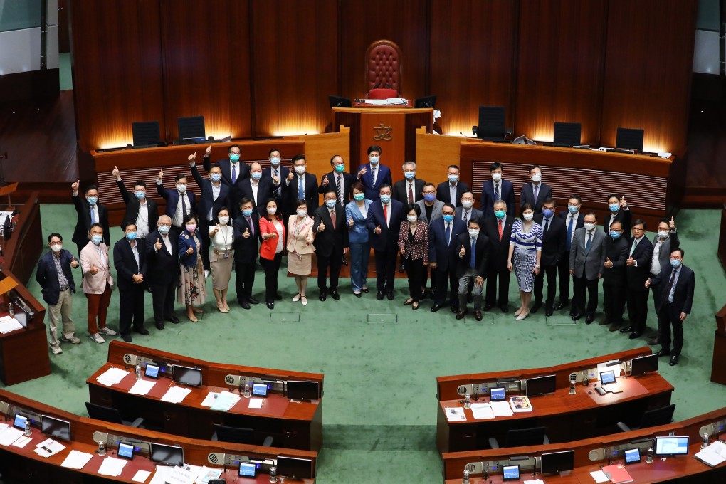 Pro-Beijing lawmakers pose for the customary group photo at the close of the 2016-2020 legislative term, in the Legislative Council chamber on July 17. For the first time since the 1997 handover, opposing lawmakers refused to come together for the ceremonial photo. All lawmakers may continue in office for an extra year, as the election was postponed due to Covid-19. Photo: Dickson Lee