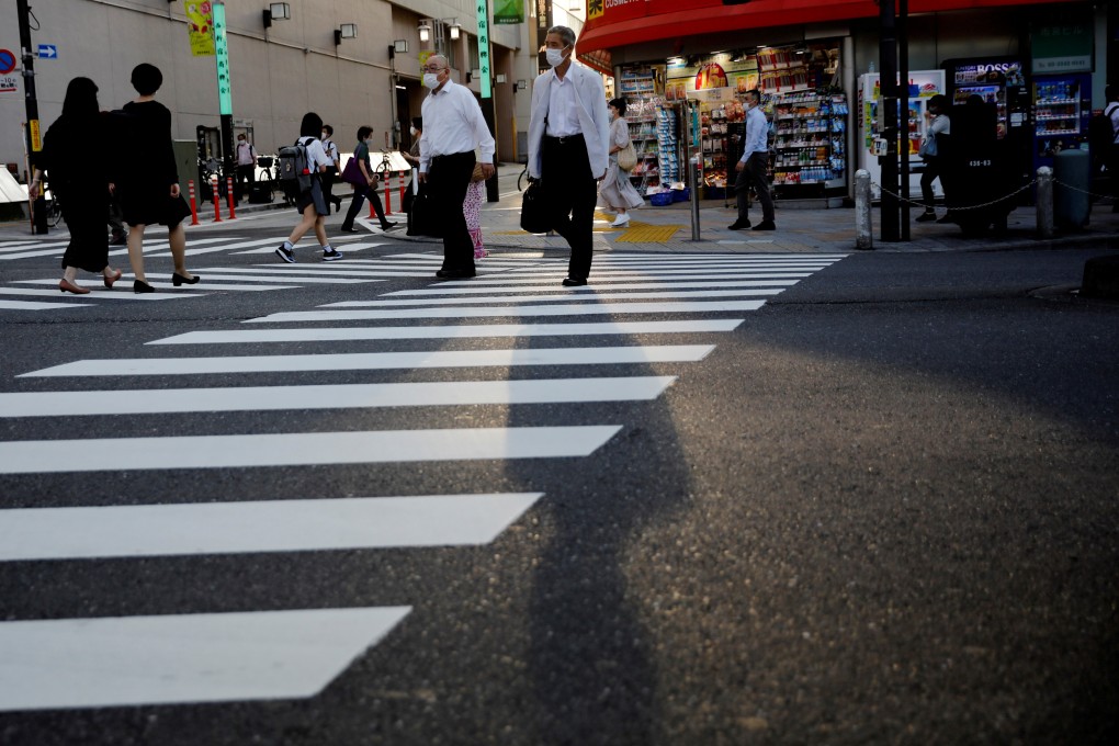 Pedestrians cross a road in Tokyo. The Japanese economy contracted at a record pace between April and June as Covid-19 restrictions curbed consumer spending. Photo: Reuters