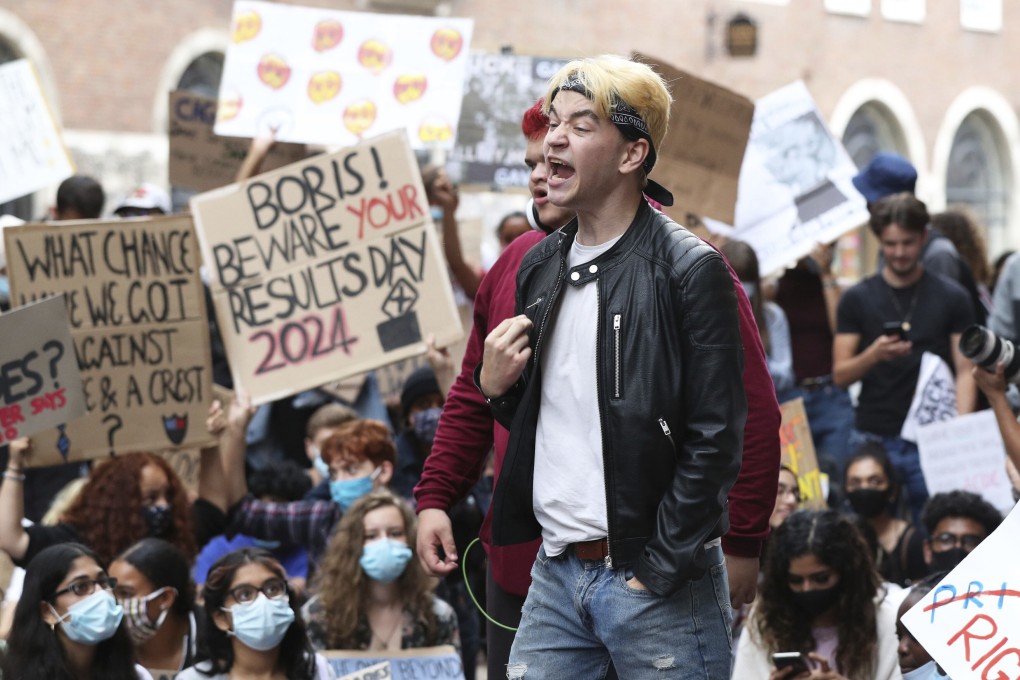 People take part in a protest outside the Department for Education in London. Photo: PA via AP