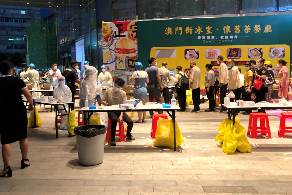 Medical workers wearing protective suits conduct nucleic testing outside the IBC Mall in Shenzhen after a worker was confirmed to have the coronavirus. Photo: Reuters