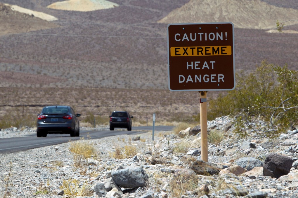 A sign warns of extreme heat as tourists enter Death Valley National Park in California in June 2013. Photo: Reuters