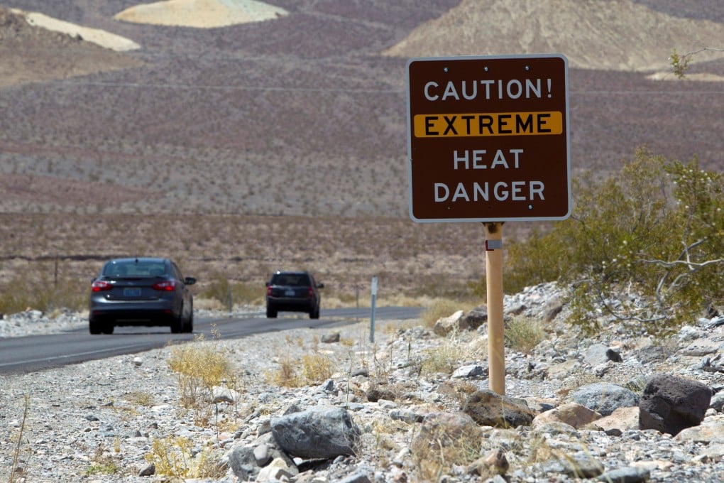 A sign warns of extreme heat as tourists enter Death Valley National Park in California in June 2013. Photo: Reuters