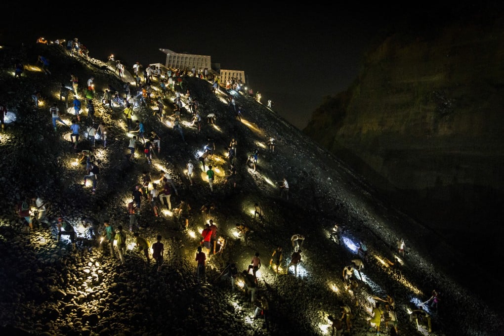 Unlicensed miners known as yemase search for jade stones by torchlight at night on a waste site in Hpakant, in Myanmar’s Kachin State, last year. Photo: Hkun Lat