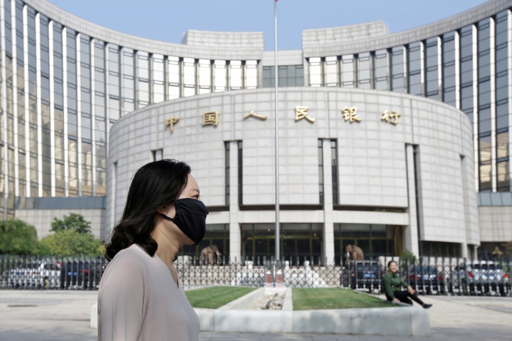 A woman walks past the headquarters of the People’s Bank of China in Beijing in 2018. The Chinese central bank’s refusal to embrace the expansionist monetary policy of its peers has left it more options as the country’s recovery from Covid-19 continues. Photo: Reuters