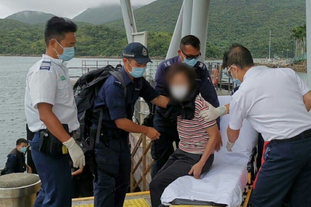 Rescuers helping the elderly woman after she was taken to shore in Sai Kung. Photo: Handout