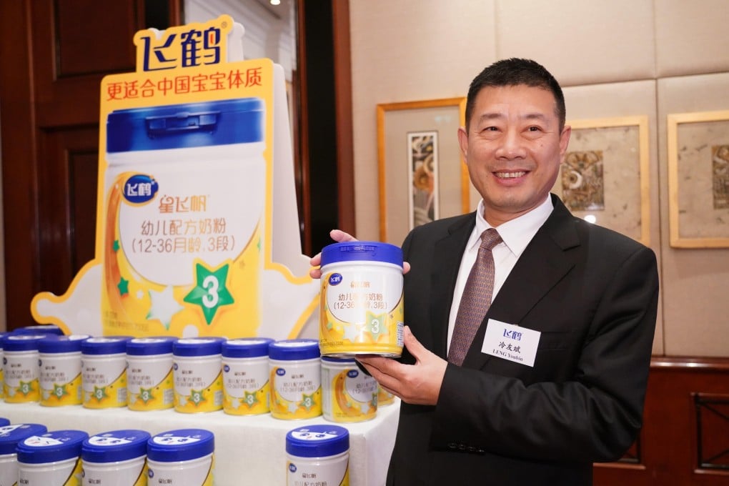 Leng Youbin, chairman of China Feihe, highlights one of its range of milk products during a media briefing on its IPO in Hong Kong October 2019. Photo: China News Service via Getty Images