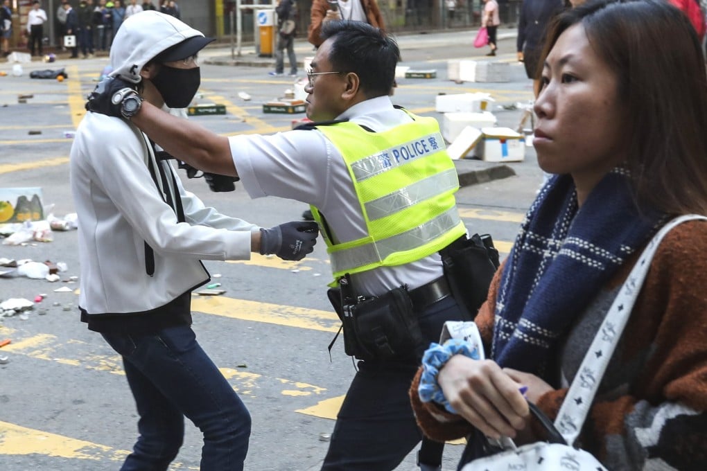 A police officer holds his gun to a protester’s chest during a protest in Sai Wan Ho last November. The officer ended up opening fire, hitting another protester (not pictured). Photos: Nora Tam