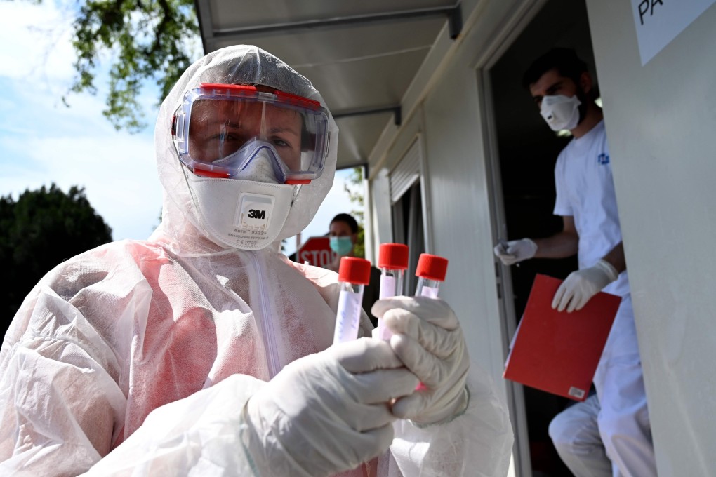 A medical worker holds test tubes with swab samples at a drive-through Covid-19 test centre in Zagreb on Monday. Photo: AFP