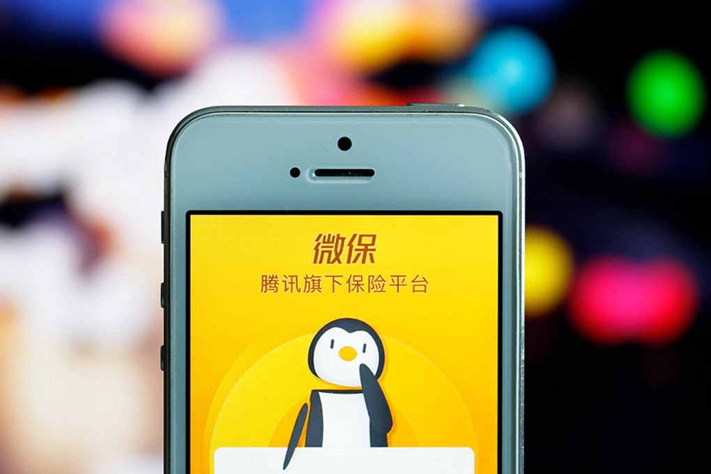 The app of Tencent WeSure Insurance is displayed on a smartphone. The online insurance platform of internet giant Tencent Holdings had more than 170 million users as of April this year. Photo: Agence France-Presse