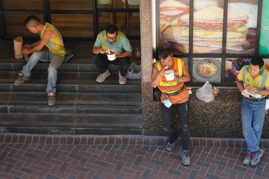 Workers eat lunch on the side of the street in Admiralty on July 30, the second day of an all-out ban on dine-in services at restaurants, as part of stricter measures against the third wave of Covid-19 infection. The ban was reversed the following day due to public pressure, but the “takeaways only” rule between 6pm and 5am was retained. Photo: Sam Tsang
