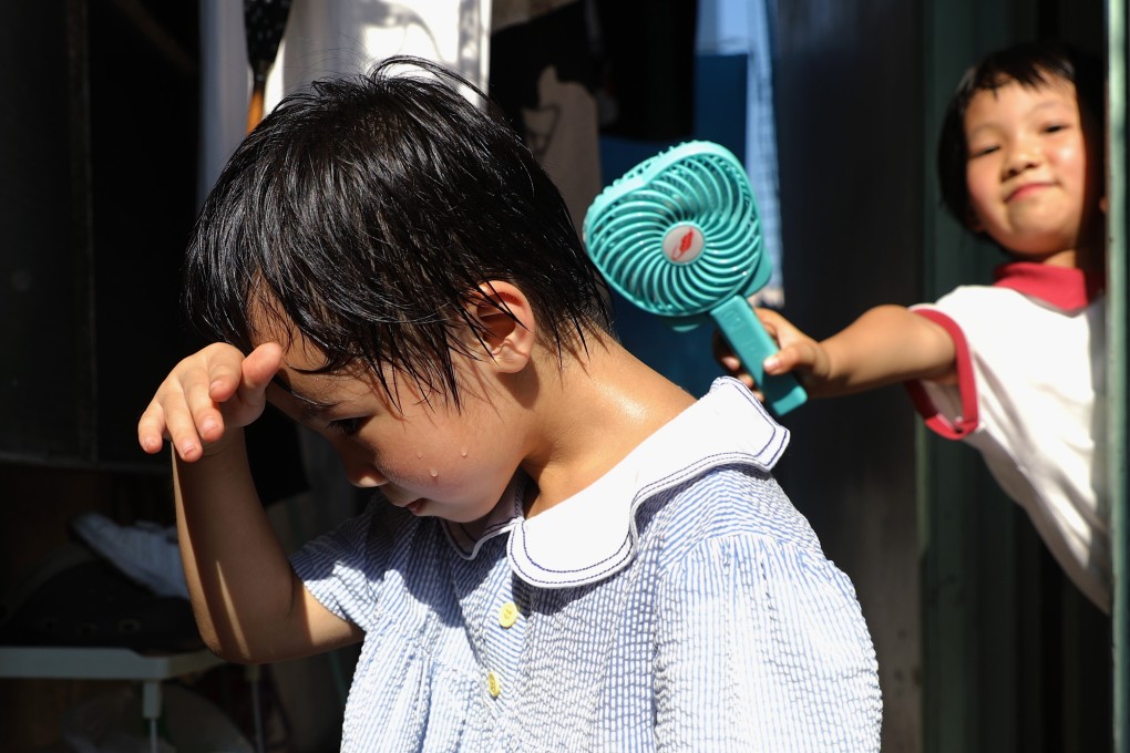 Children try to cope during a record heatwave in Hong Kong over two weeks in May 2018. Unchecked climate change is expected to make extreme weather events more frequent. Photo: Sam Tsang