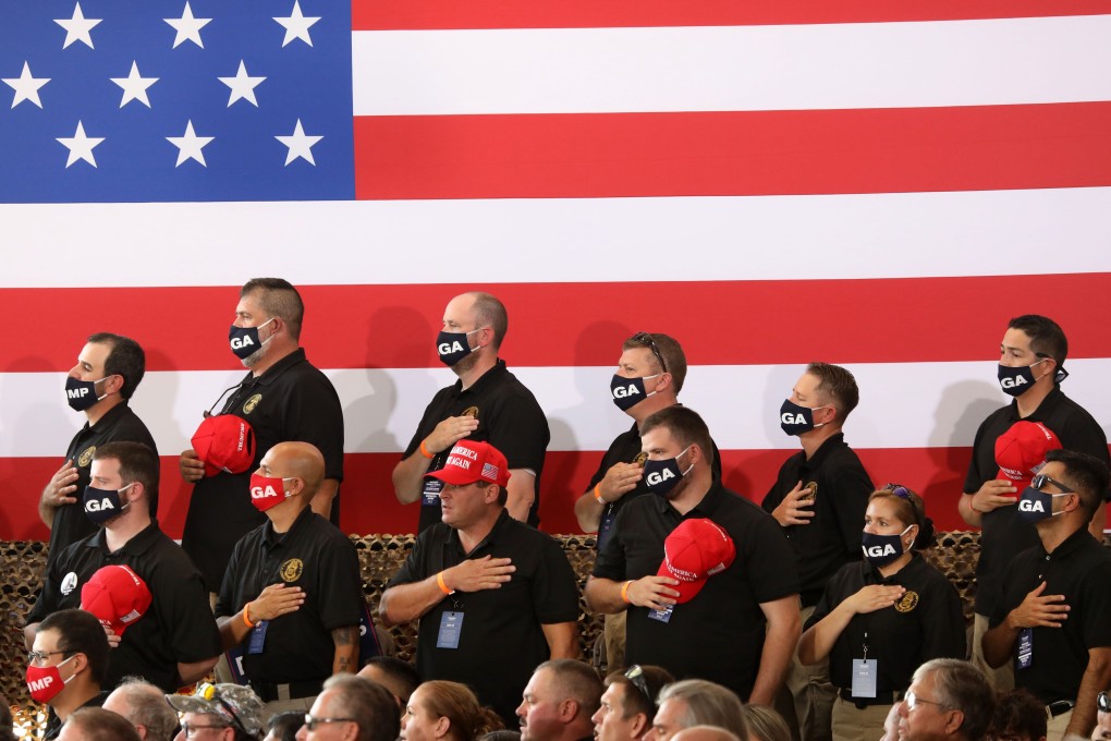 Supporters of US President Donald Trump stand for the national anthem before a campaign rally on August 18 in Yuma, Arizona. Trump is currently trailing his Democratic rival Joe Biden in the polls but it would be a mistake to write off his chances. His base is more passionate about him than Democrats are about Biden. Photo: Getty Images / AFP