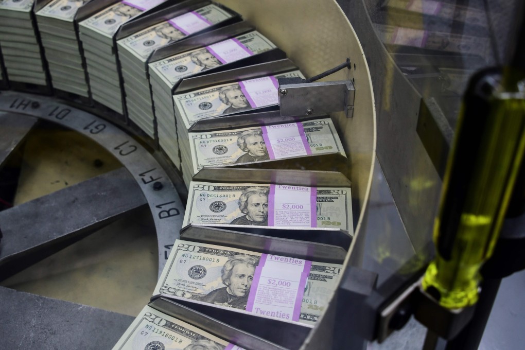 Packs of freshly printed US dollar notes are processed for bundling and packaging at the US Bureau of Engraving and Printing in Washington in July 2018. Photo: AFP
