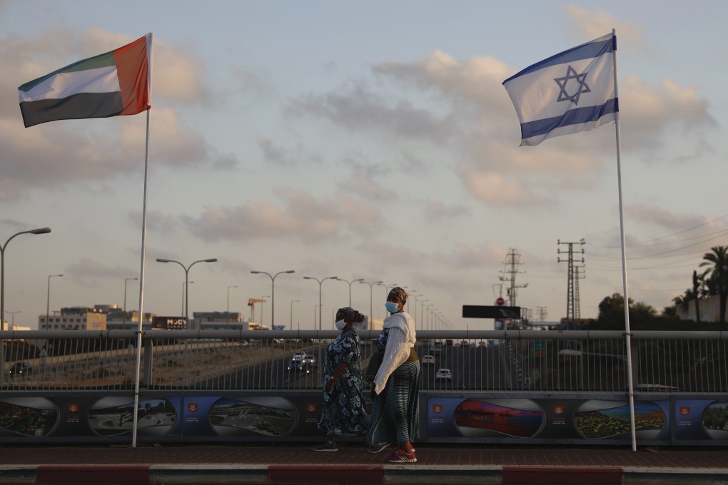 The flags of the United Arab Emirates and Israel fly at the Peace Bridge in Netanya, Israel, after the two countries agreed to diplomatic recognition. Photo: AP