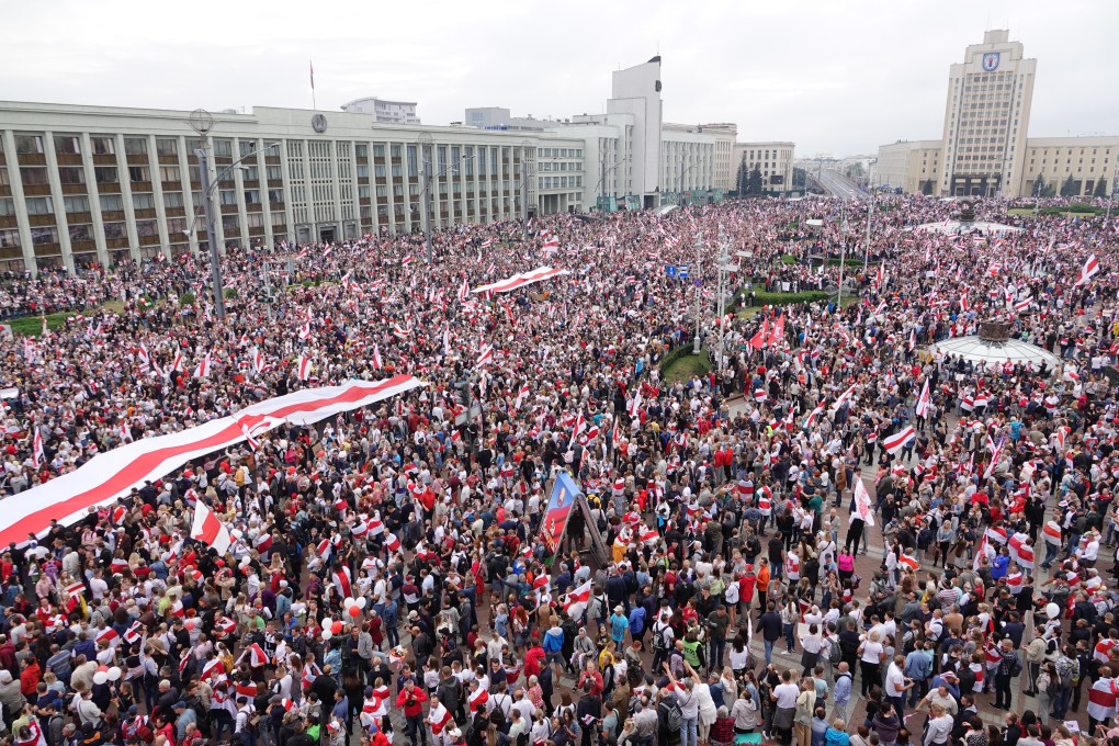 Demonstrators carrying Belarusian opposition flags pictured protesting against Belarusian President Alexander Lukashenko at Minsk’s Independence Square on Sunday. Photo: DPA