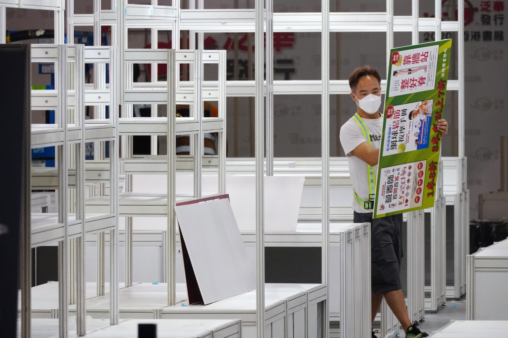A worker takes down a booth after the Hong Kong Book Fair was cancelled. Photo: Sam Tsang