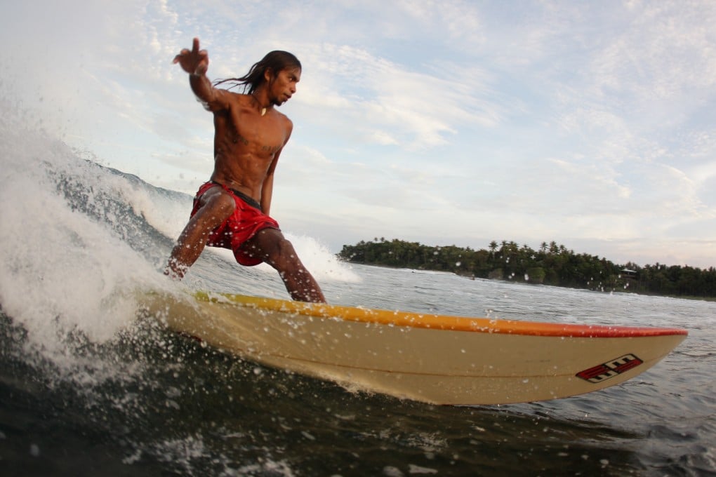 A surfer rides a wave at Cloud 9 in Siargao. Photo: Getty Images