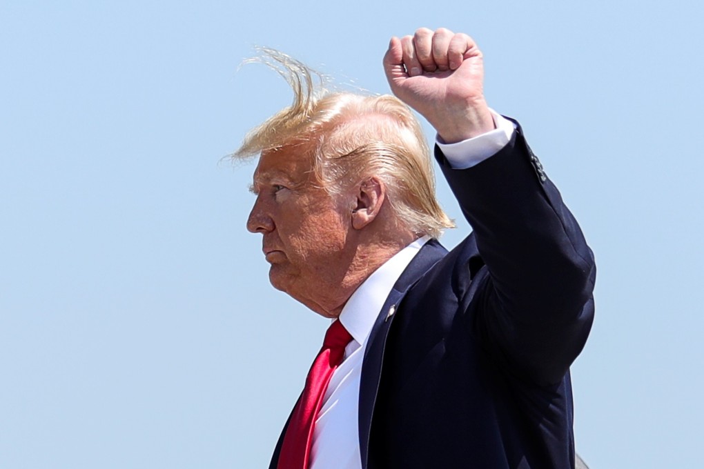 US President Donald Trump raises his fist as he arrives at Bangor International Airport in Maine, US, on June 5. Photo: Reuters