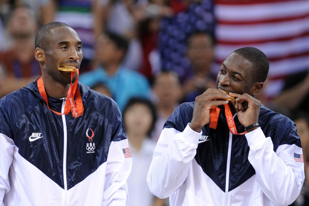 Team USA's Kobe Bryant and Dwyane Wade bite their gold medals on the podium after at the Beijing 2008 Olympic Games. Photo: AFP