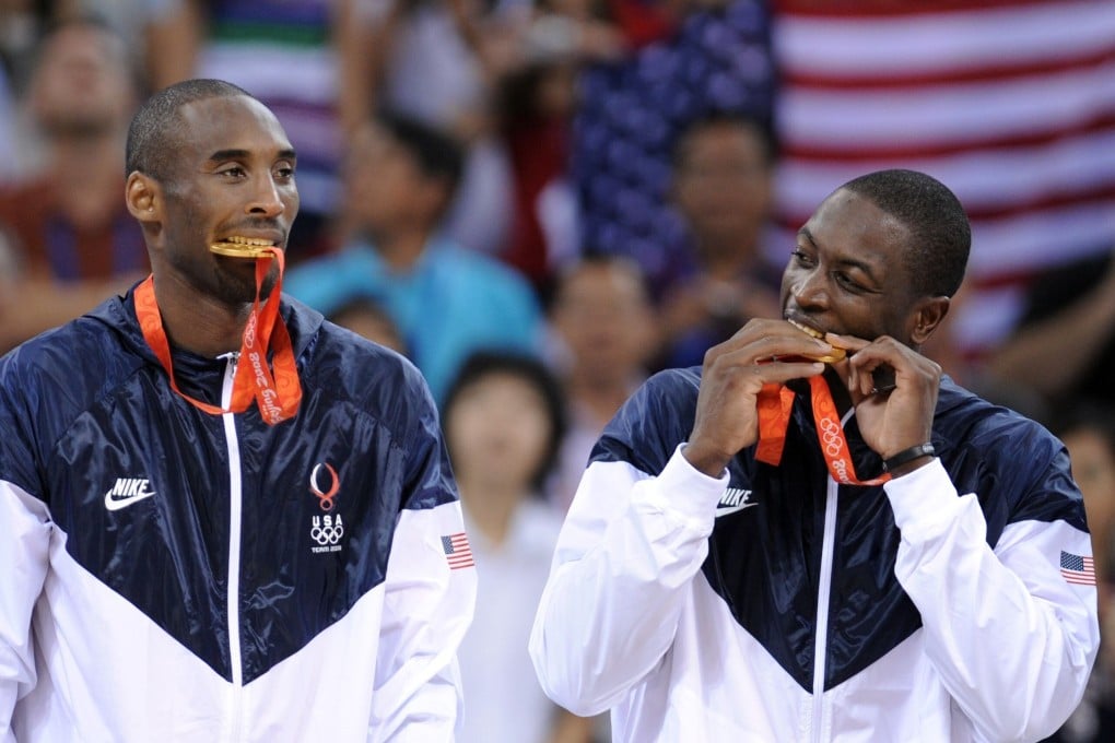 Team USA's Kobe Bryant and Dwyane Wade bite their gold medals on the podium after at the Beijing 2008 Olympic Games. Photo: AFP