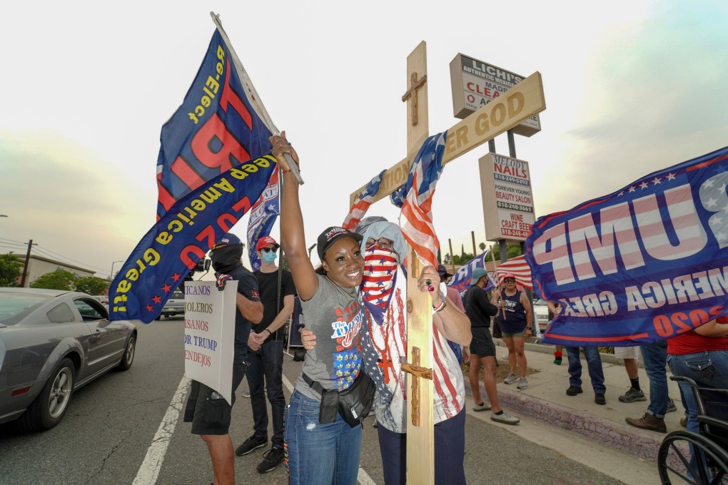Trump supporters embrace during a rally in Tujunga, near Los Angeles, on Friday. Photo: AFP
