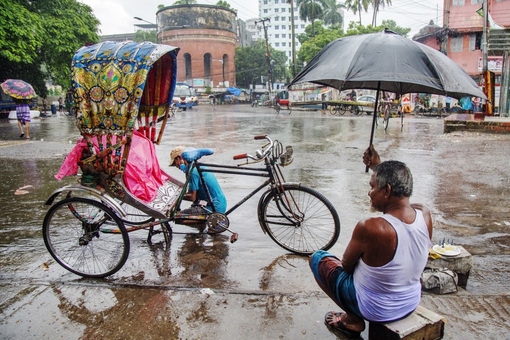 A rickshaw puller during the rain in Dhaka, Bangladesh. Photo: EPA