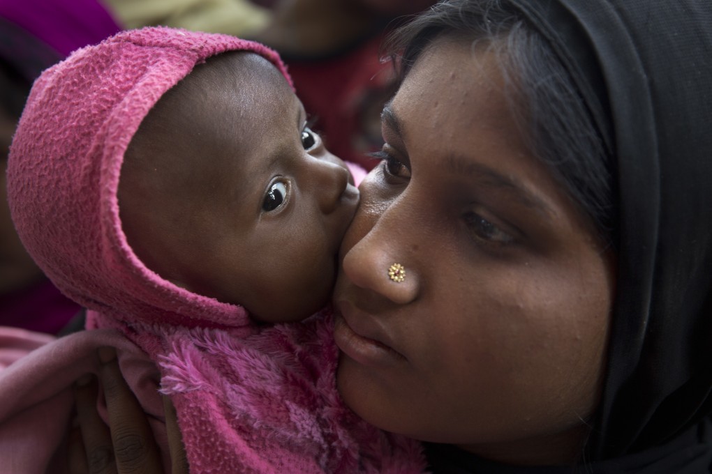 A newly arrived Rohingya refugee and her child wait at a food distribution line in the Kutupalong refugee camp near Cox’s Bazar, Bangladesh, in January 2018. More than 75,000 babies have been born in the camps of Cox’s Bazar in the past three years. Photo: AP