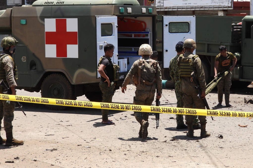 Soldiers at the site of an explosion in the town of Jolo, Sulu province, southern Philippines on Monday. The attacks have been blamed on Islamic militants. Photo: AP