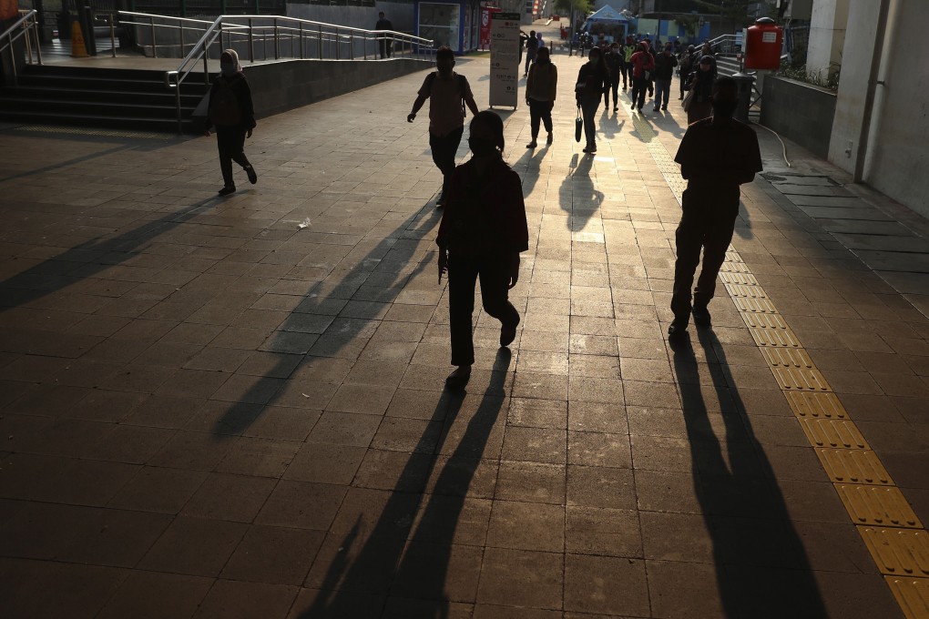 Pedestrians in Jakarta wear face masks as a precaution against the spread of Covid-19. Photo: AP