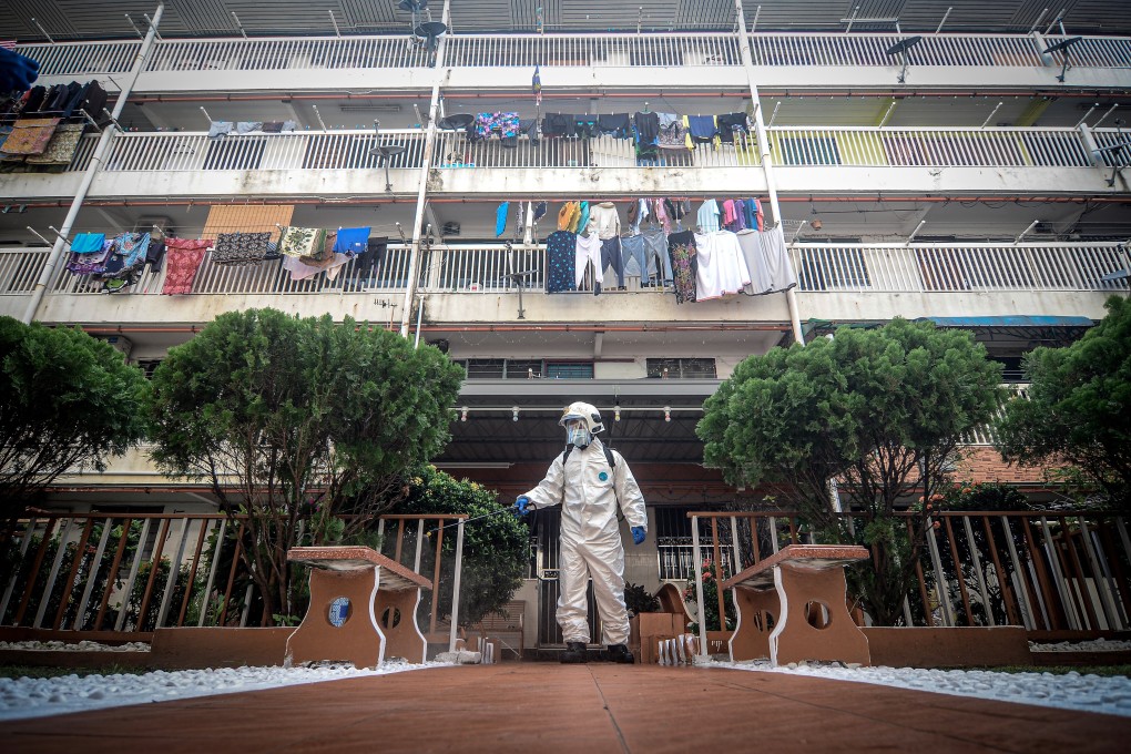 Fire and Rescue personnel sanitise the area around apartment buildings in Malaysia during the Covid-19 pandemic. Photo: DPA