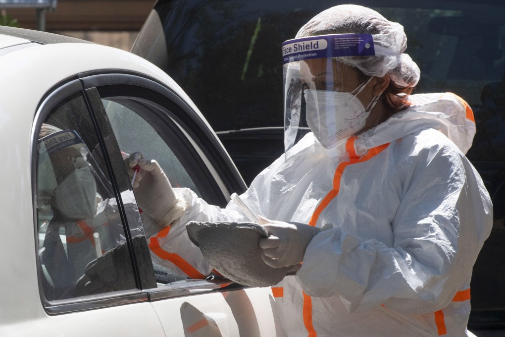Health workers take swab samples from motorists for Covid-19 tests, at the drive-in testing facility at the San Giovanni Addolorata Hospital in Rome, Italy. The WHO says cases are declining. Photo: EPA-EFE