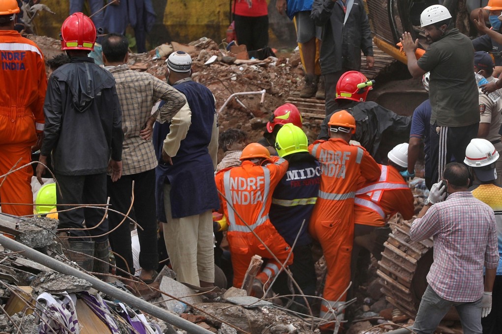 Rescuers carry a four-year-old boy from the rubble of a collapsed five-storey building in Mahad in Raigad district in the western state of Maharashtra, India. Photo: Reuters