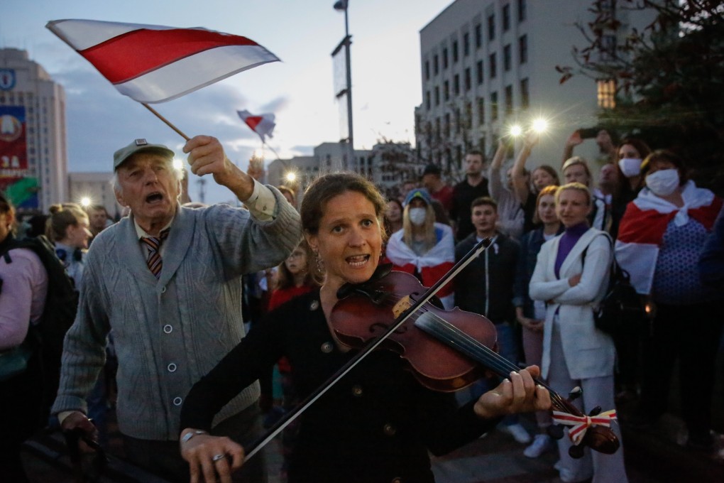 A woman plays the violin in Minsk on Monday during a protest against the results of the Belarus presidential elections. Photo: EPA-EFE