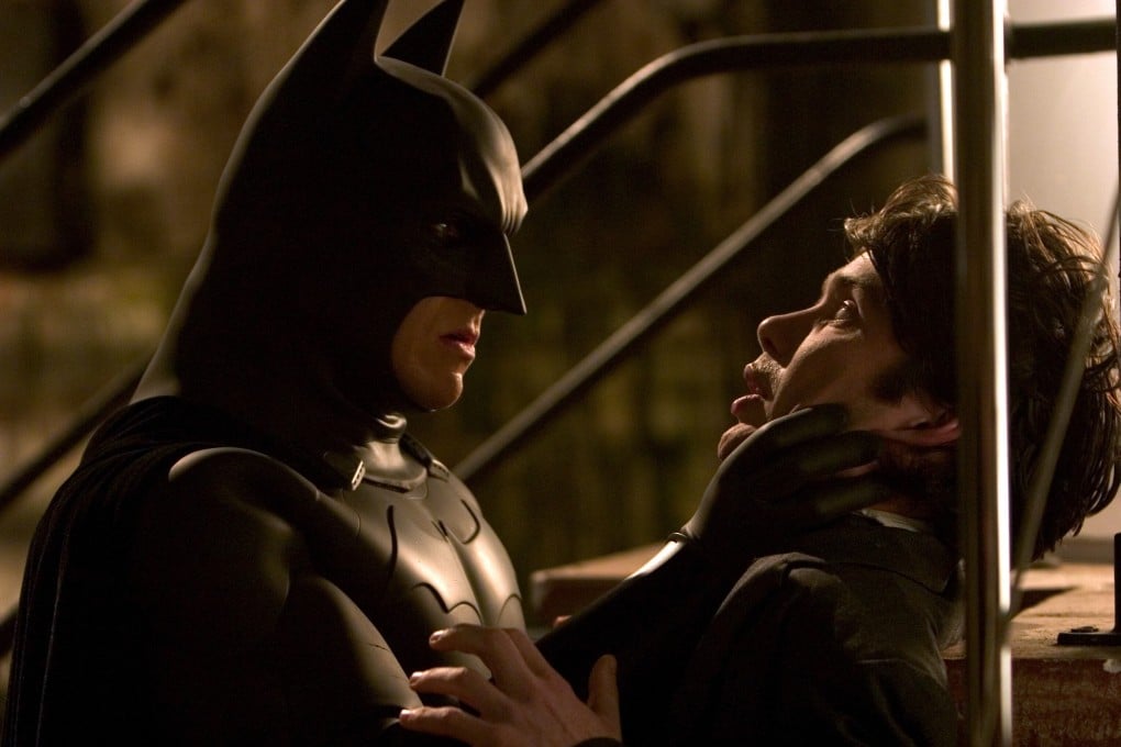 Christian Bale and Cillian Murphy in a still from Batman Begins (2005) – one of our top movies that take mask-wearing to the next level.